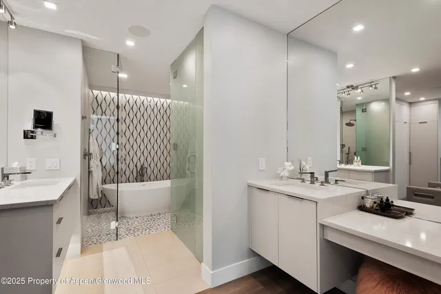 a bathroom with a double vanity sink mirror and toilet