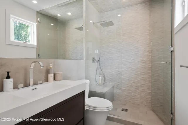 a bathroom with a sink toilet and shower