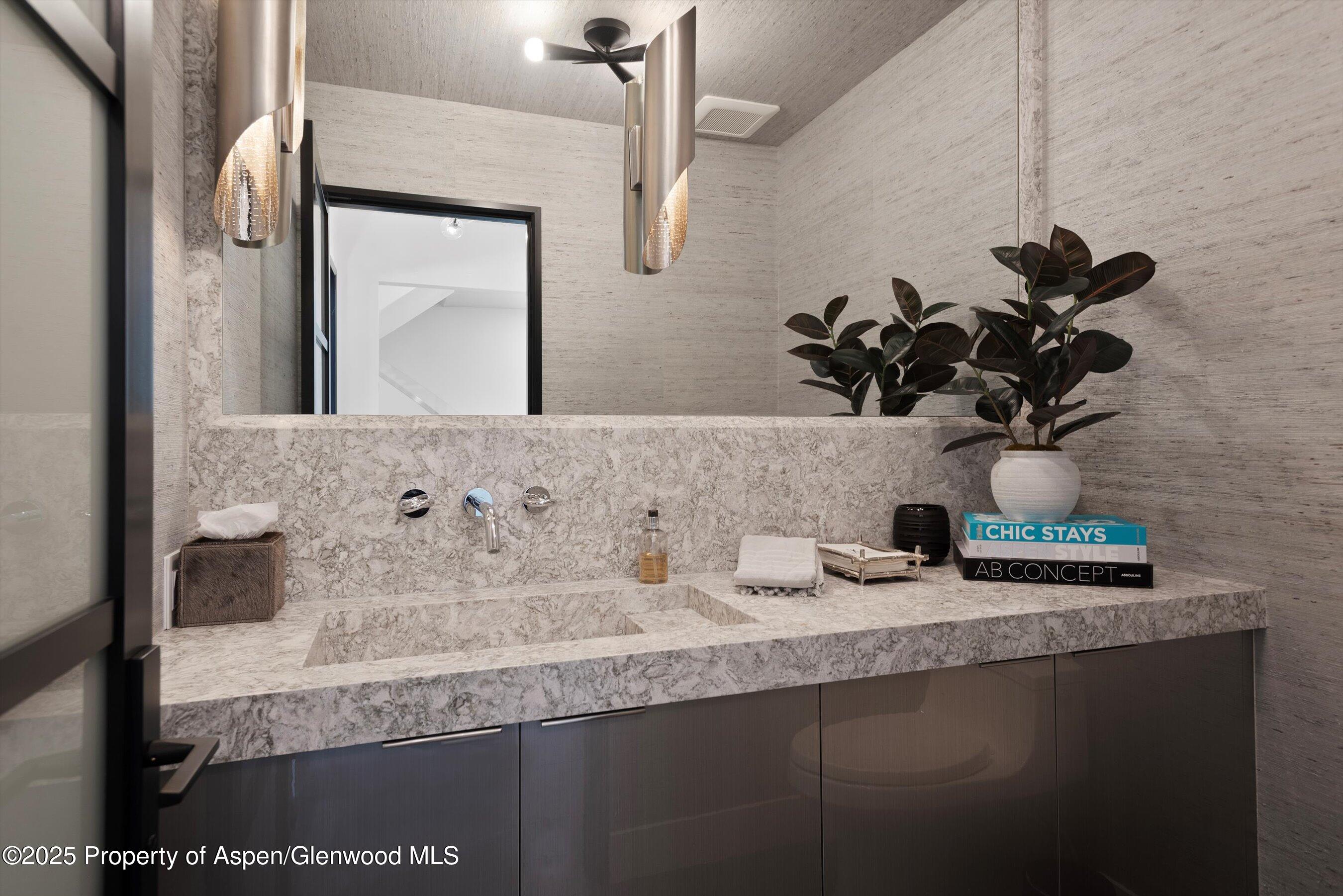 120 South Spring Street, Unit 1 Aspen, CO 81611 - Photo 22 of 37 a bathroom with a sink and a mirror
