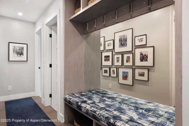 a bedroom with a bed and painting on the wall