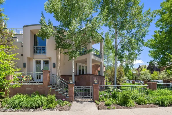 front view of house with a tree in front of it