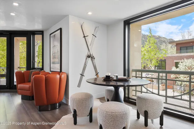 a dining room with furniture and a large window
