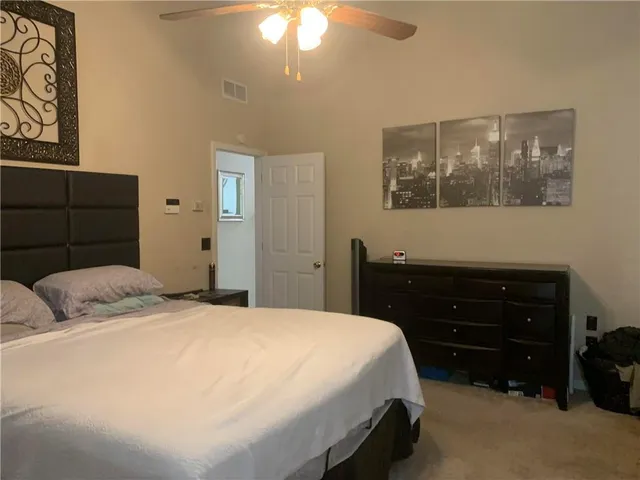 a bedroom with a bed and cabinets