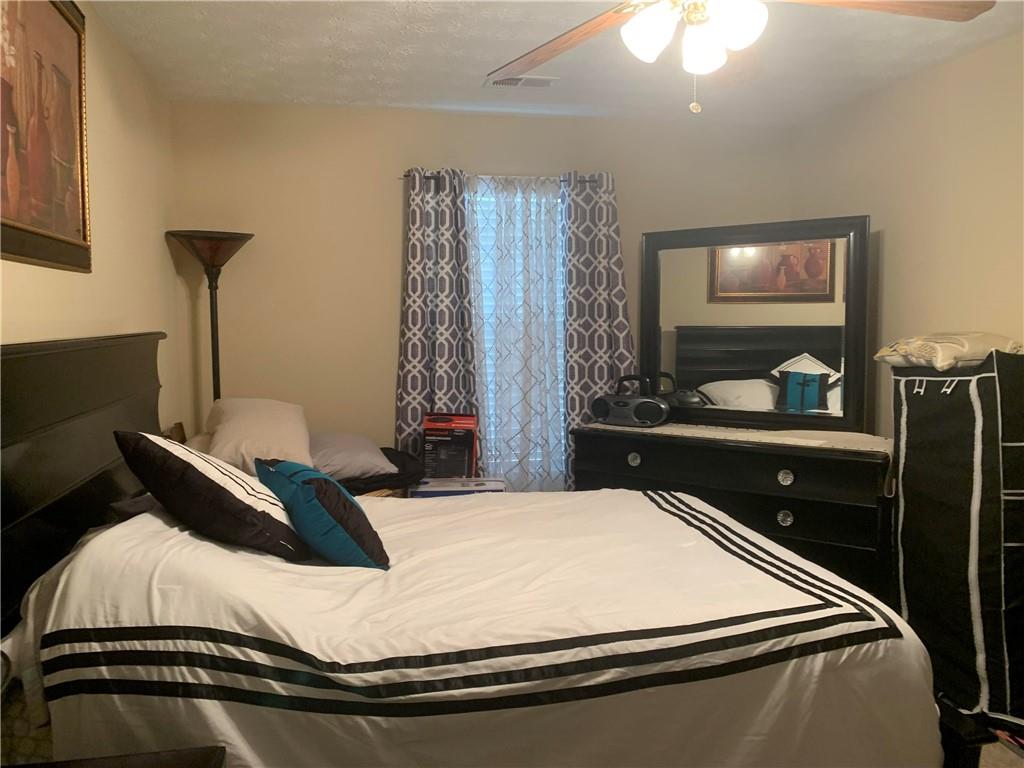 200 Syracuse Lane Covington, GA 30016 - Photo 16 of 22 a bedroom with a bed and a flat screen tv