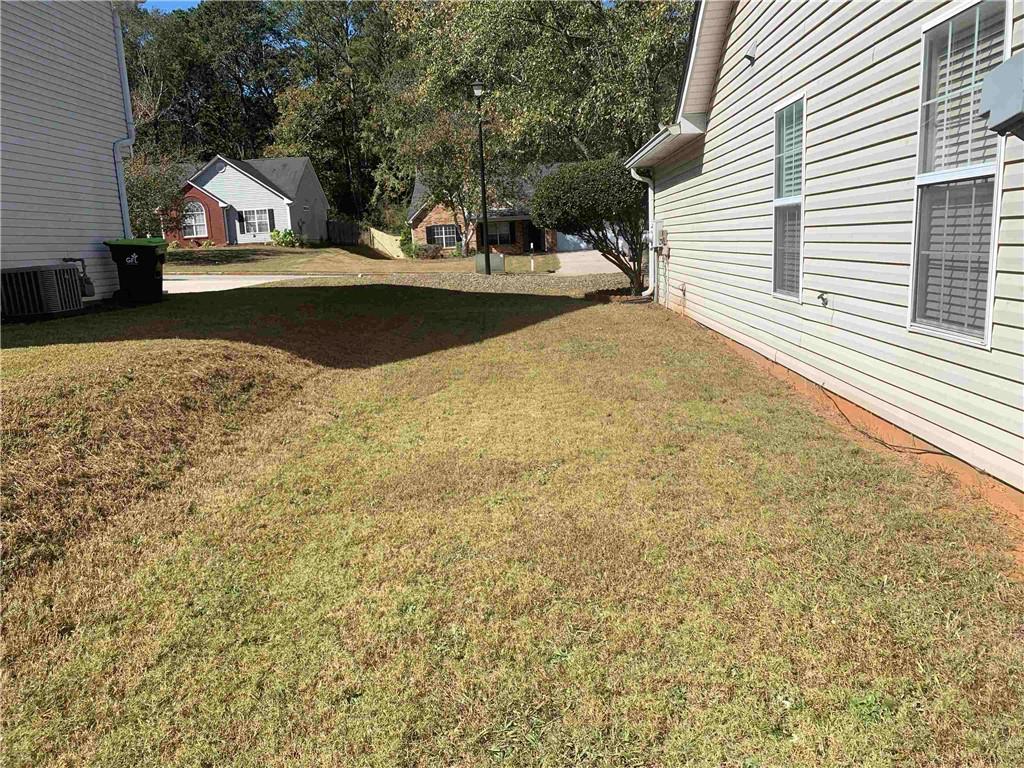 200 Syracuse Lane Covington, GA 30016 - Photo 22 of 22 a front view of a house with a yard and garage