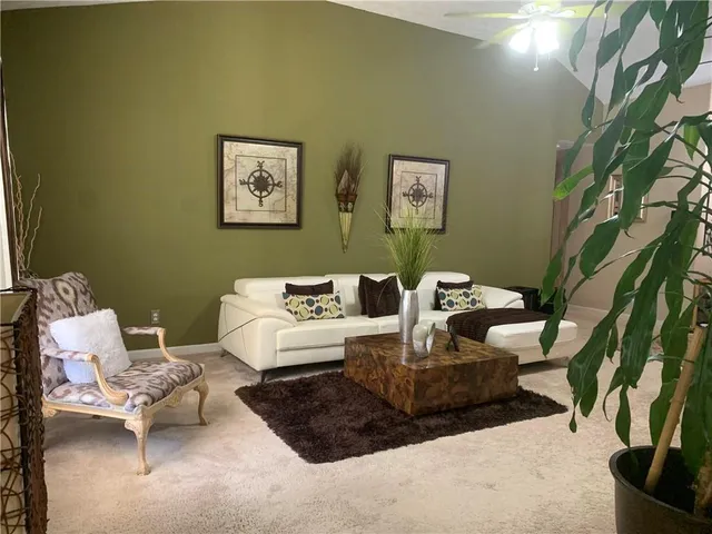 a living room with furniture and a potted plant