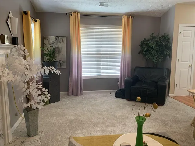 a bedroom with a bed table and chair