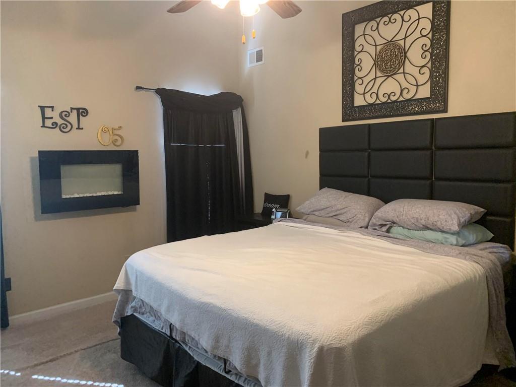 200 Syracuse Lane Covington, GA 30016 - Photo 10 of 22 a bedroom with a bed and a painting on the wall