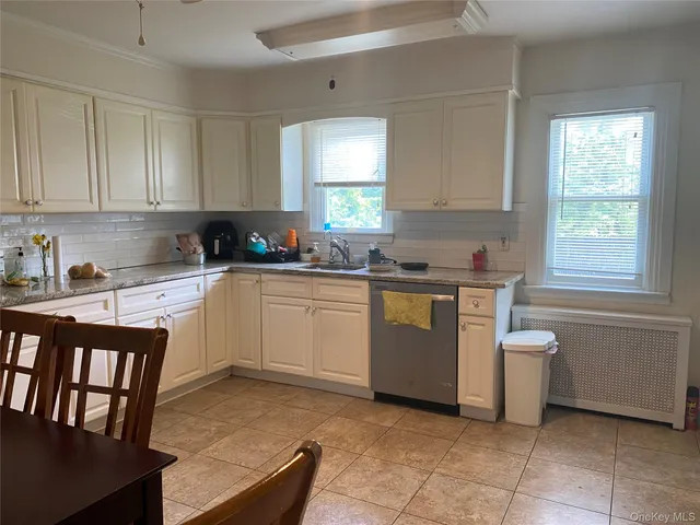 a kitchen with a sink a stove and cabinets