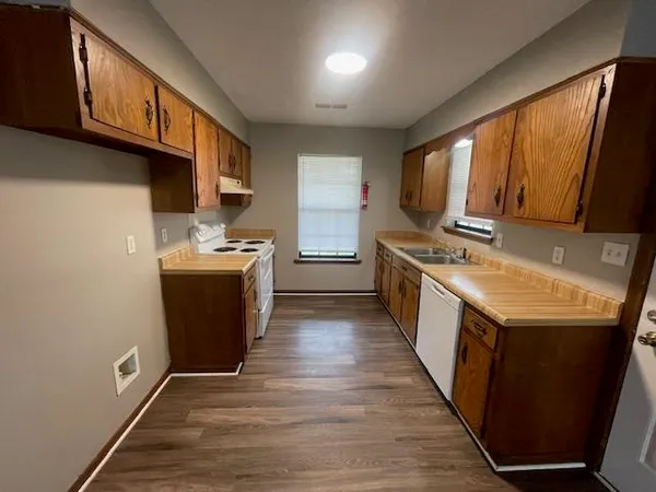 a kitchen with stainless steel appliances granite countertop a stove a sink dishwasher and a microwave oven with cabinets