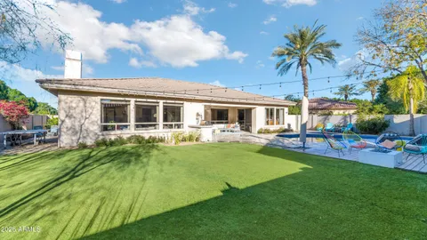 a view of a house with a backyard