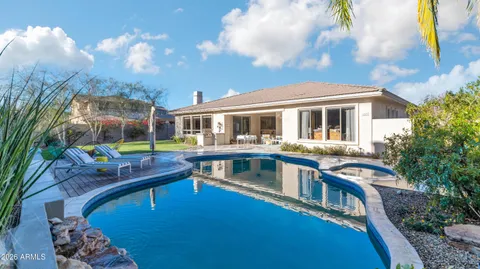 a view of house with a swimming pool