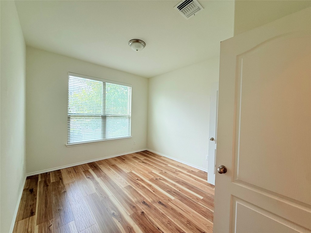 1140 Yellow Iris Road Leander, TX 78641 - Photo 15 of 23 Empty room featuring light wood-style flooring and baseboards