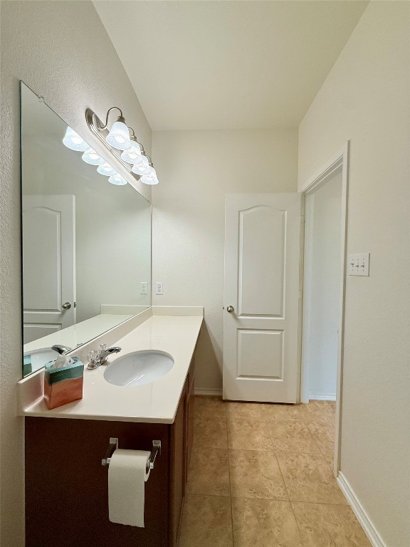 1140 Yellow Iris Road Leander, TX 78641 - Photo 17 of 23 Bathroom featuring vanity and light tile patterned floors