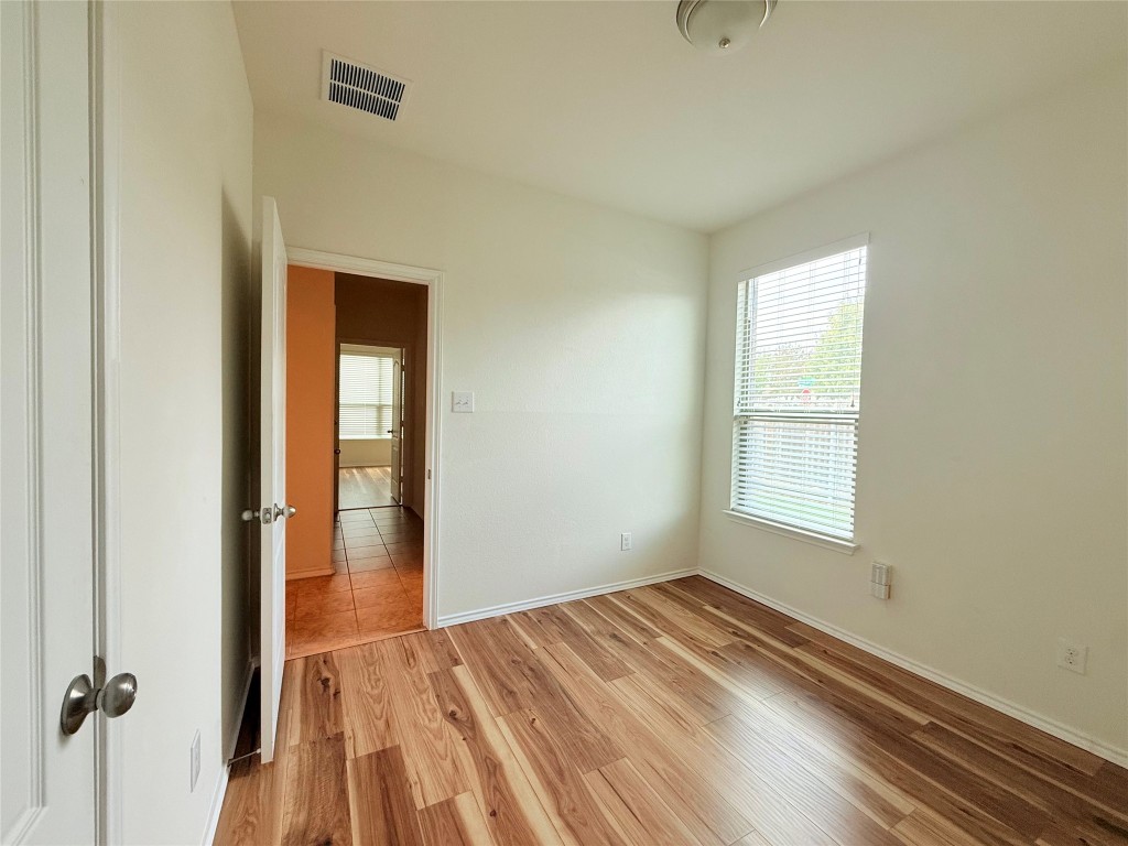 1140 Yellow Iris Road Leander, TX 78641 - Photo 19 of 23 Unfurnished room with light wood-style floors and plenty of natural light
