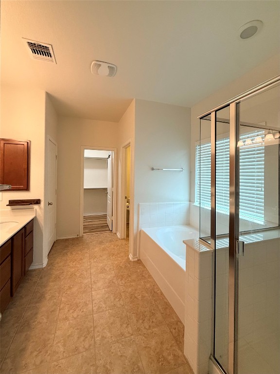 1140 Yellow Iris Road Leander, TX 78641 - Photo 20 of 23 Full bathroom with vanity, a garden tub, a shower stall, and a spacious closet
