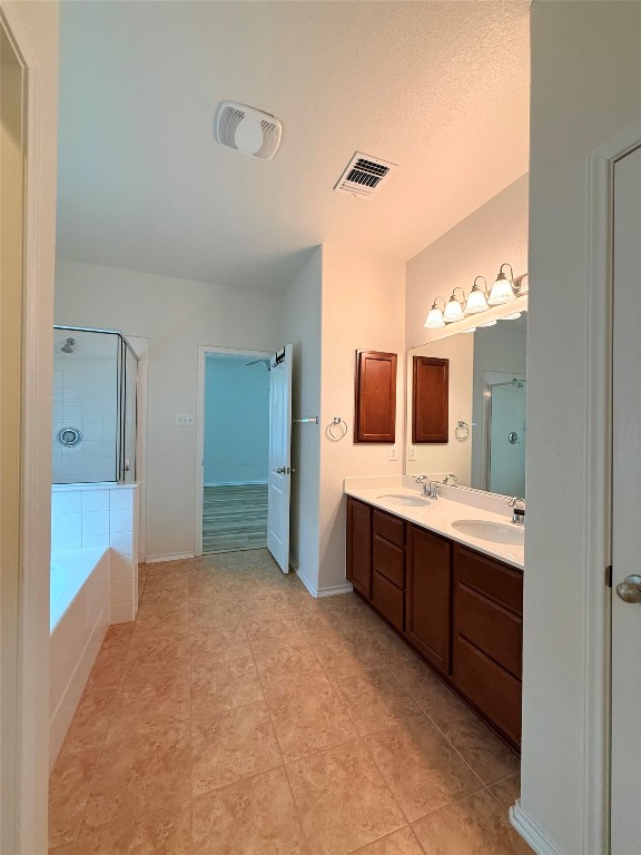 1140 Yellow Iris Road Leander, TX 78641 - Photo 21 of 23 Full bathroom featuring double vanity, a bath, and a stall shower