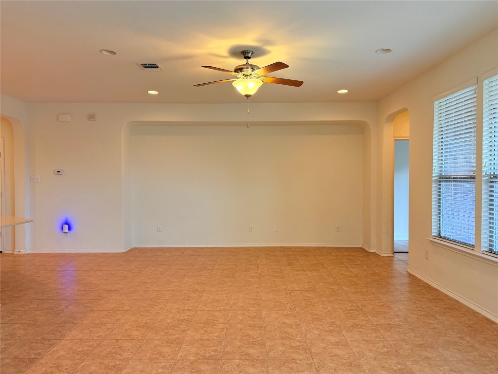 1140 Yellow Iris Road Leander, TX 78641 - Photo 8 of 23 Empty room featuring arched walkways, recessed lighting, and ceiling fan