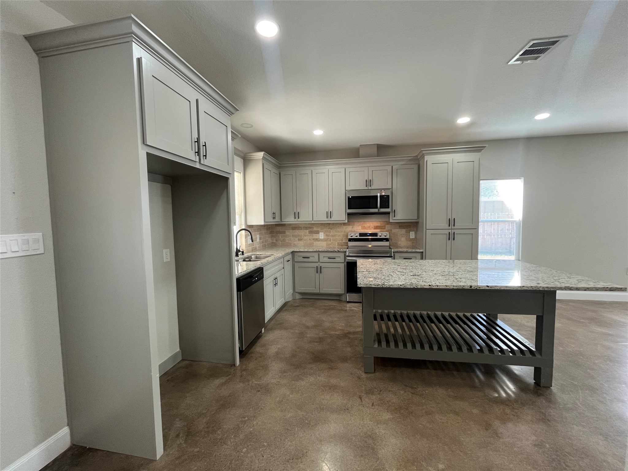 30023 Rosebud Street Magnolia, TX 77354 - Photo 7 of 21 a kitchen with stainless steel appliances granite countertop a refrigerator sink and cabinets
