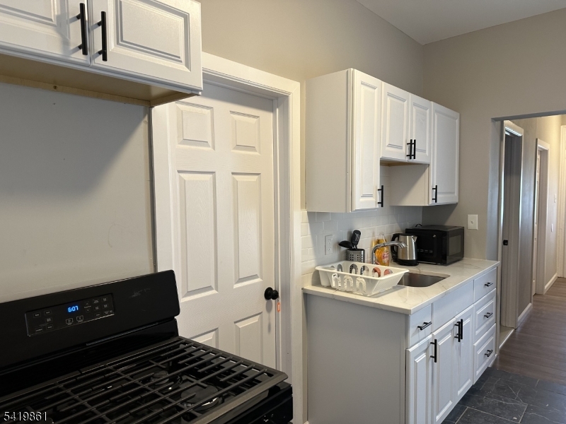 34 Duryea Street Newark, NJ 07103 - Photo 3 of 15 a kitchen with a stove and a refrigerator