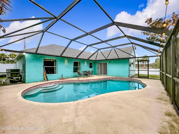 a view of a backyard with a tub and wooden fence