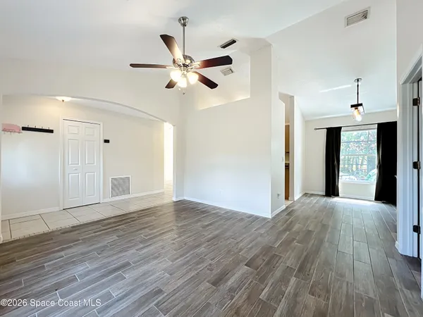 a view of an empty room and wooden floor
