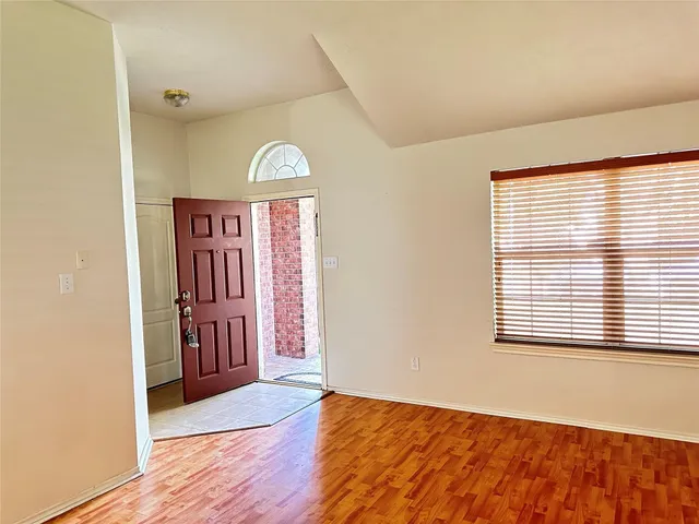 a view of front door with wooden floor