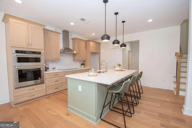a kitchen with stainless steel appliances kitchen island a large island in the center