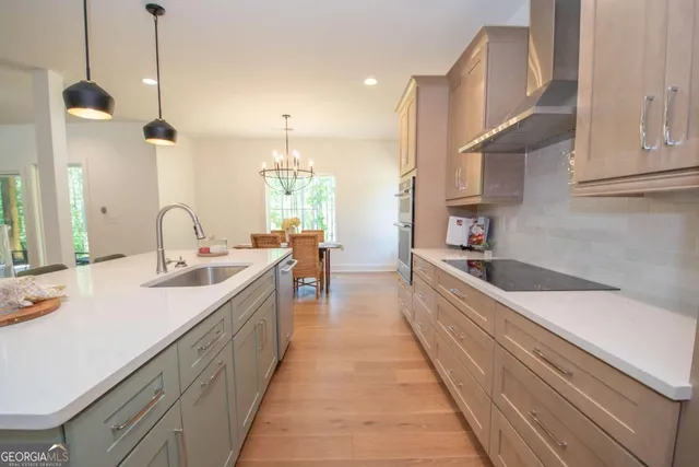 a large kitchen with kitchen island a sink a counter space and stainless steel appliances