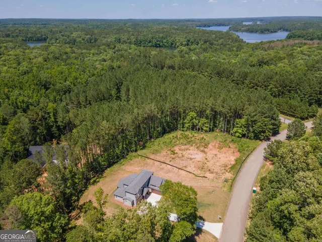 an aerial view of residential houses with outdoor space and swimming pool