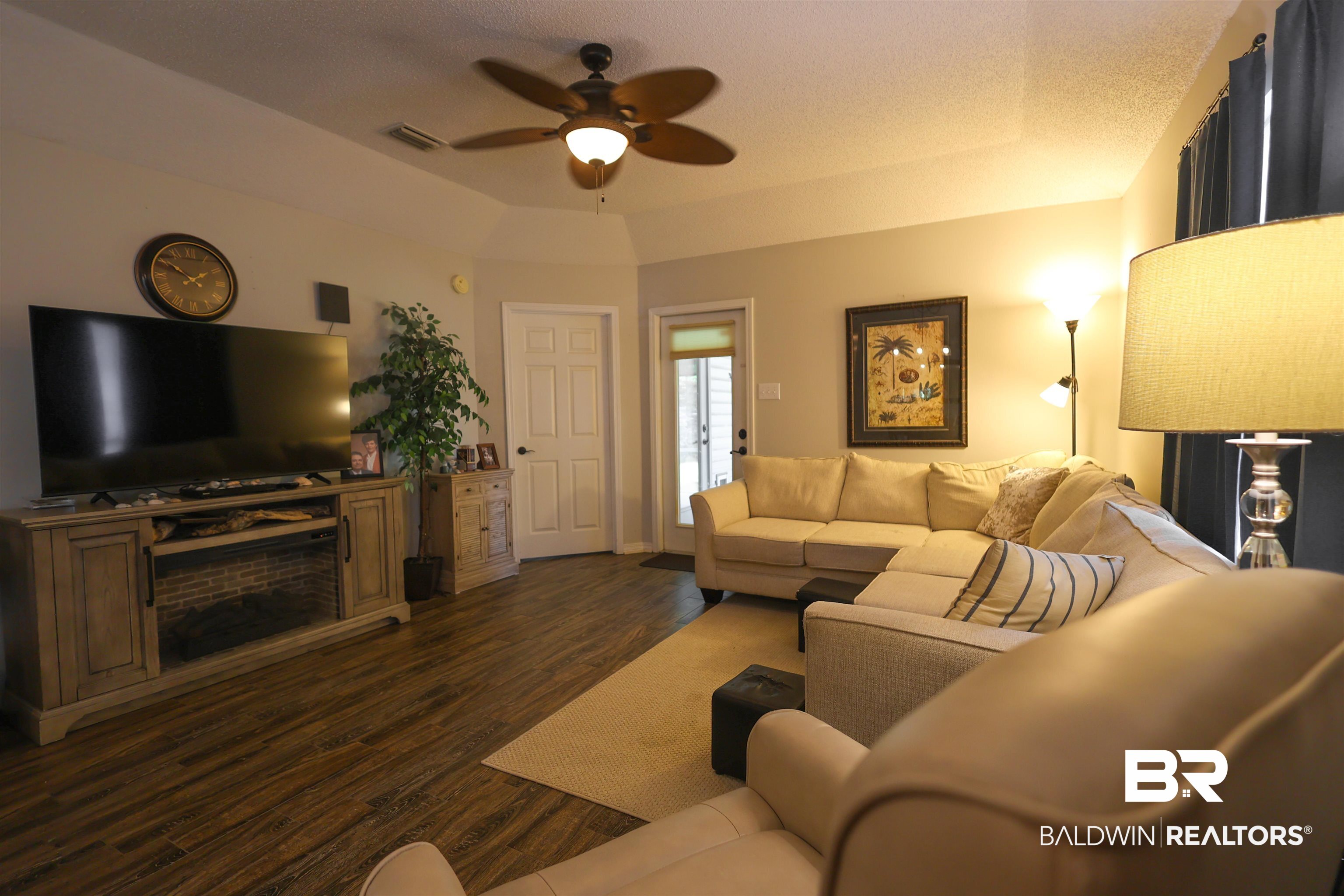 7790 Audubon Drive Foley, AL 36535 - Photo 16 of 39 Spacious living area featuring wood-finish flooring and a ceiling fan with integrated lighting