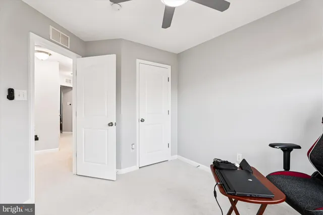 a view of room with furniture and a ceiling fan