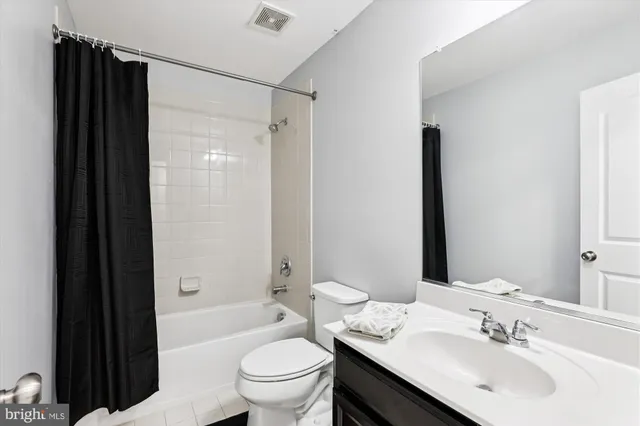 a bathroom with a sink a toilet a mirror and shower