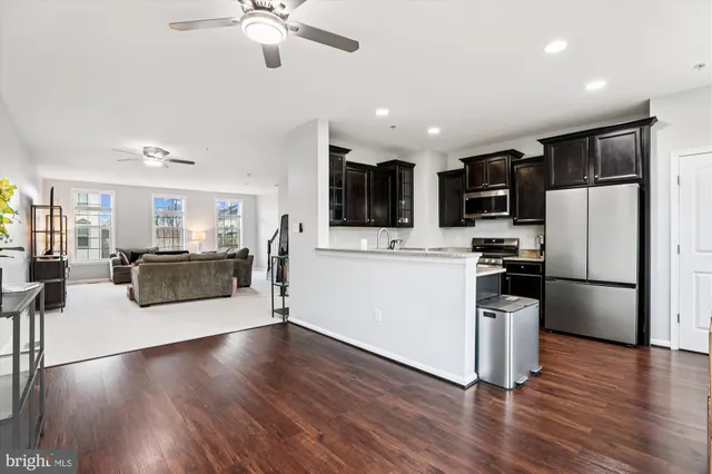 a kitchen with stainless steel appliances a refrigerator sink and microwave