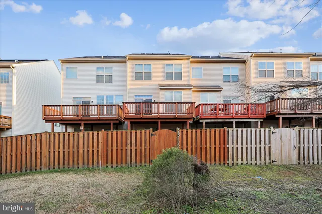 a view of a house with a wooden deck