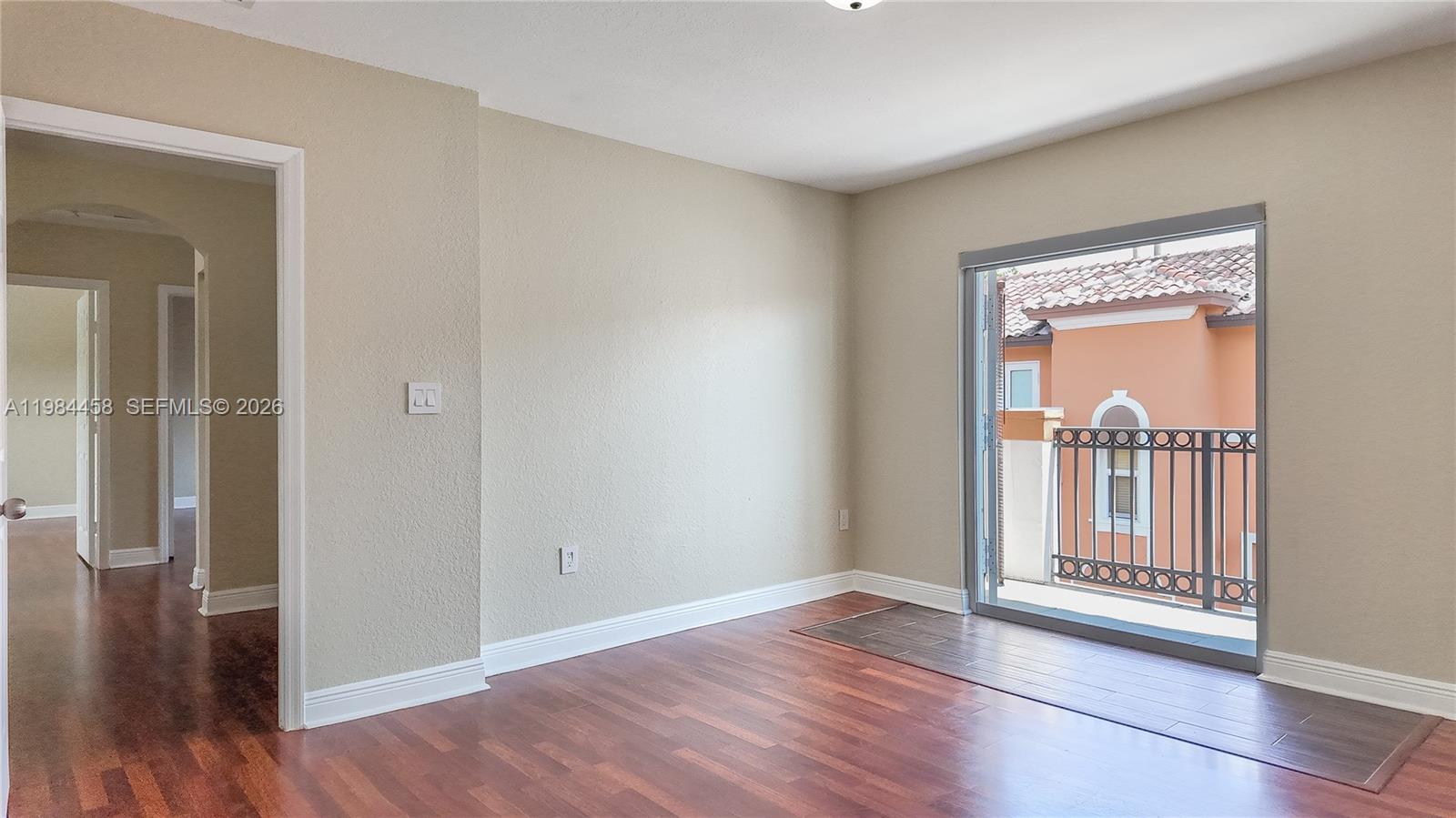 6002 Southwest 8th Street, Unit 3 West Miami, FL 33144 - Photo 6 of 10 a view of a hallway with wooden floor and a bedroom