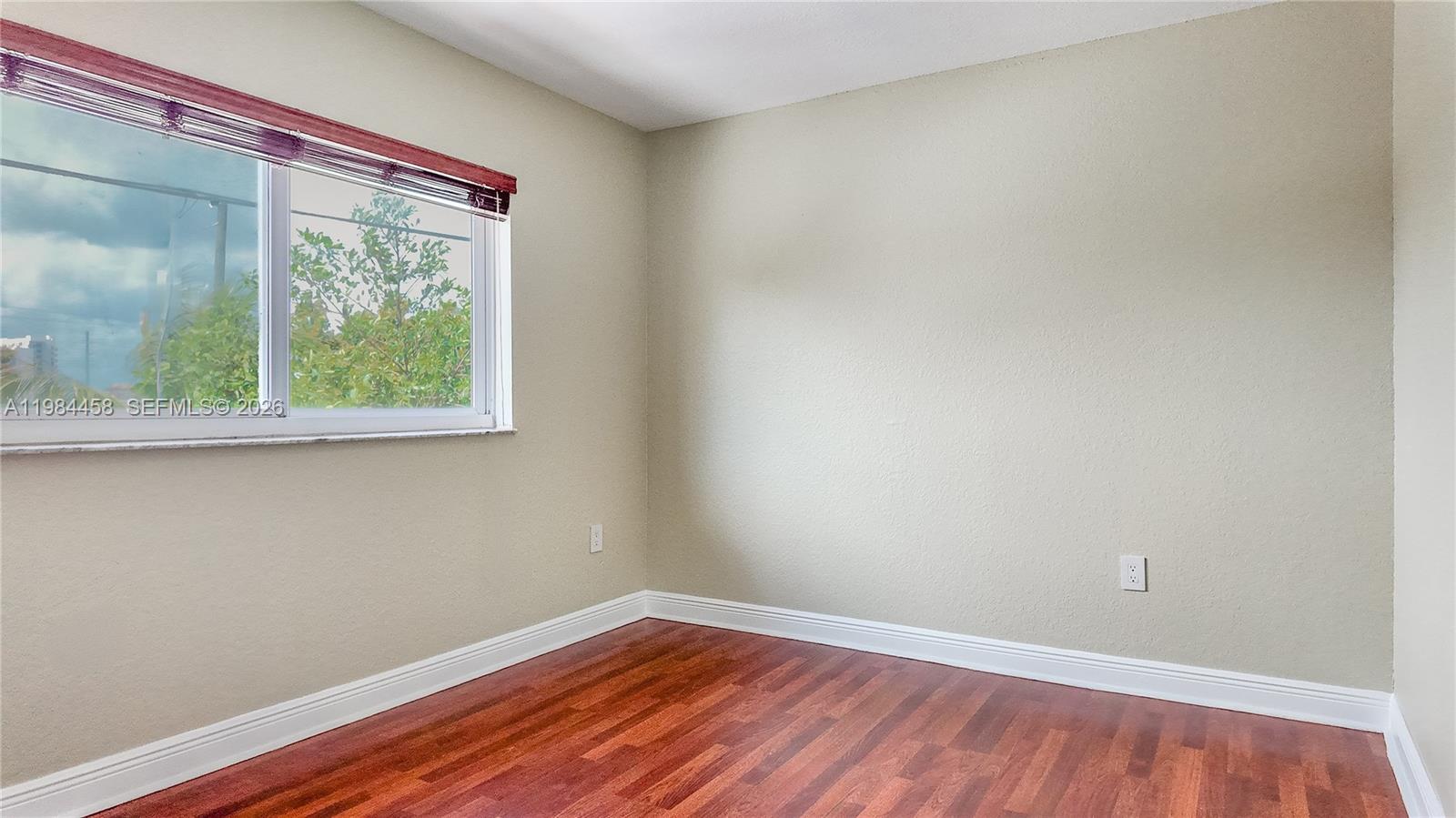 6002 Southwest 8th Street, Unit 3 West Miami, FL 33144 - Photo 8 of 10 a view of a small space with wooden floor and a window