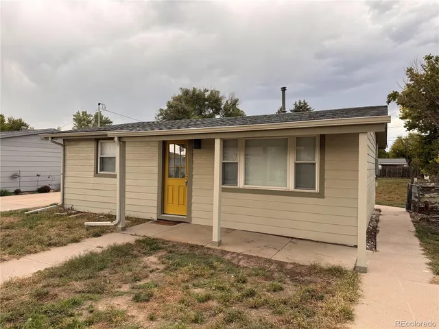 a view of a house with wooden fence