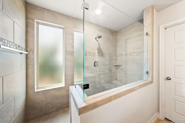 a bathroom with a shower and a bathtub