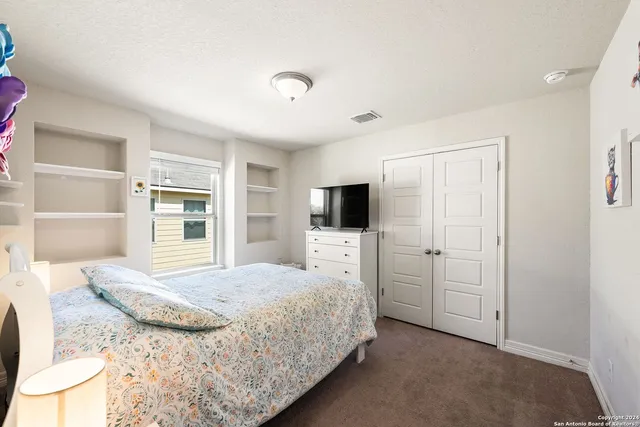 a bedroom with a bed and a television