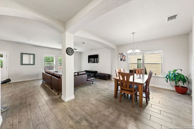 a view of a dining room with furniture and a window