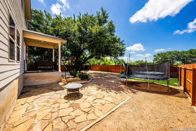 a view of a backyard with sitting area