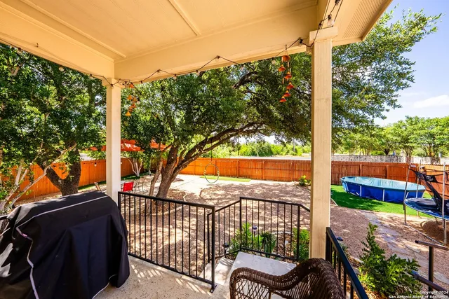 a view of a porch with furniture and a yard