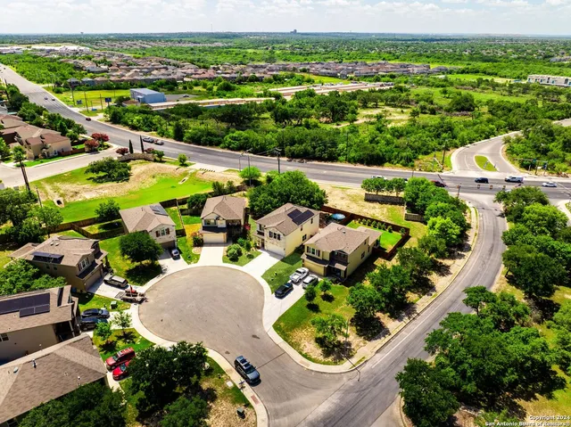 an aerial view of residential houses with outdoor space