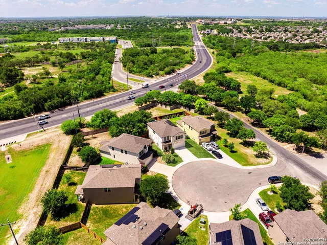 an aerial view of residential houses with outdoor space