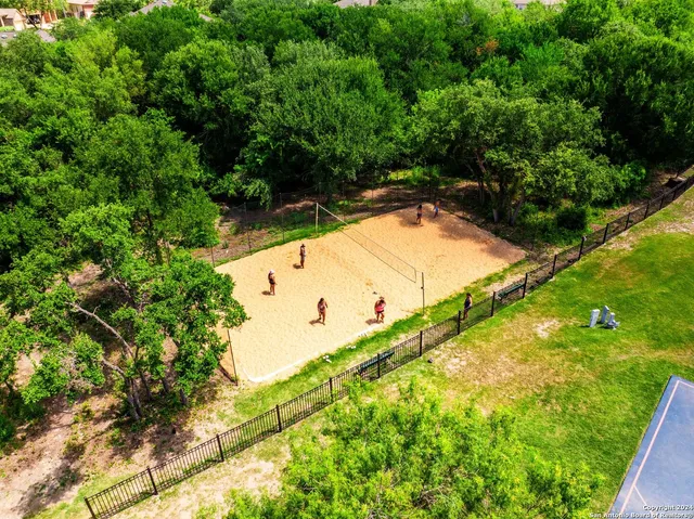 an aerial view of a house with swimming pool and outdoor seating