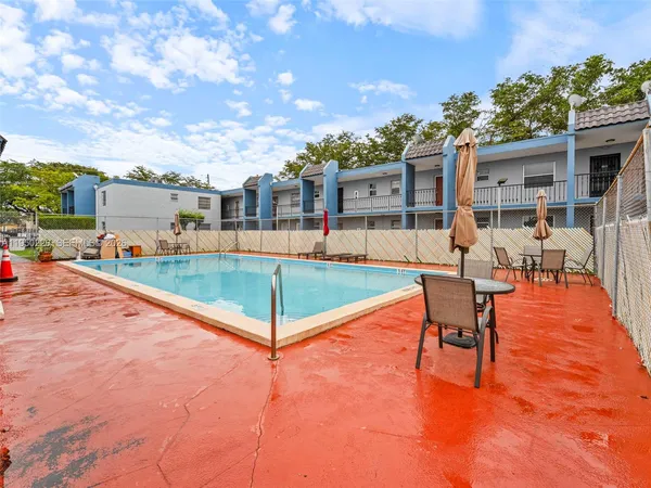 an outdoor space with pool and furniture