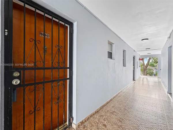 a view of hallway with wooden floor and entryway