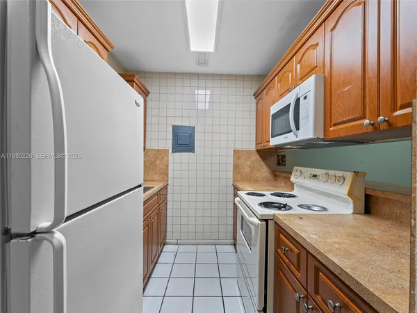 a kitchen with stainless steel appliances granite countertop a refrigerator and a stove