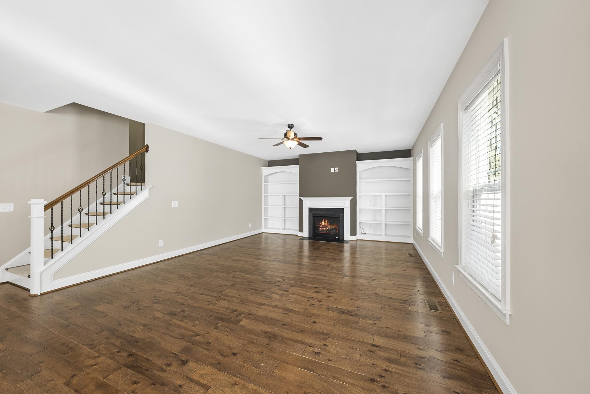 1109 Azadia Court Raleigh, NC 27603 - Photo 20 of 52 a view of an empty room with wooden floor fireplace and a window
